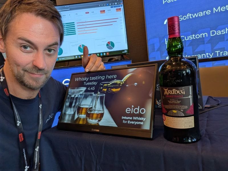The Eido stand with a screen advertising a whisky tasting and a bottle beside it.
