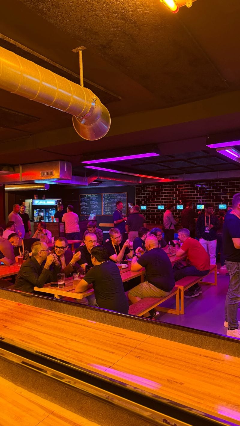 People gathered around the shuffleboard tables.